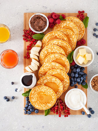 american pancake board with bacon berries maple syrup butterの写真素材