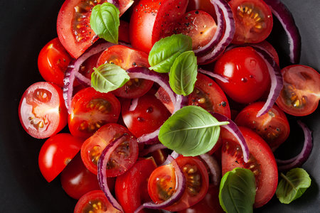 healthy tomato salad with onion basil olive oil and balsamic vinegarの写真素材