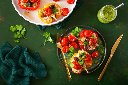 stuffed bell peppers with quinoa tomatoes olives and herb sauce chimichurriの写真素材