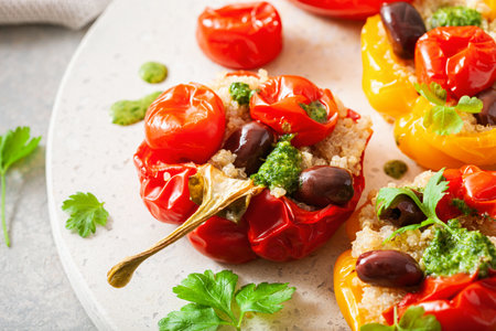 stuffed bell peppers with quinoa tomatoes olives and herb sauce chimichurriの写真素材