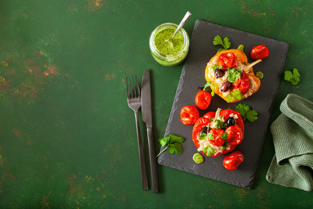 stuffed bell peppers with quinoa tomatoes olives and herb sauce chimichurriの写真素材