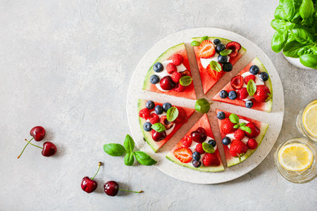 watermelon pizza slices with yogurt and berries, summer dessertの写真素材