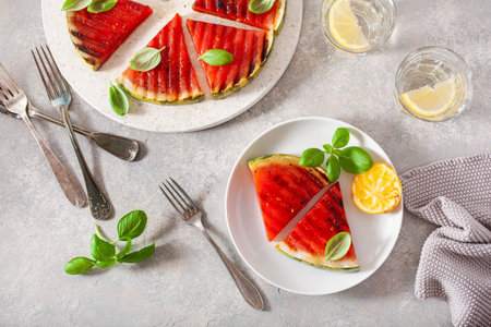 grilled watermelon slices with lemon and basil. summer dessertの写真素材