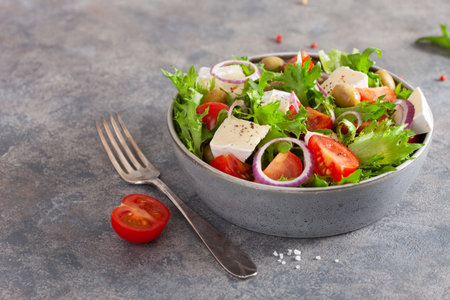 tomato salad with brie cheese olives onion lettuceの写真素材