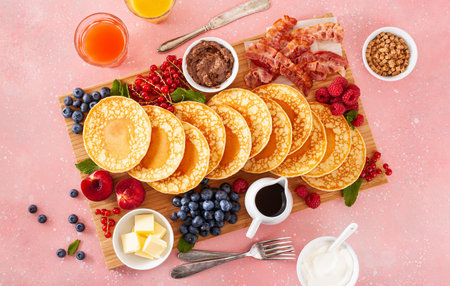 american pancake board with bacon berries maple syrup butterの写真素材