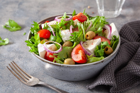 tomato salad with brie cheese olives onion lettuceの写真素材