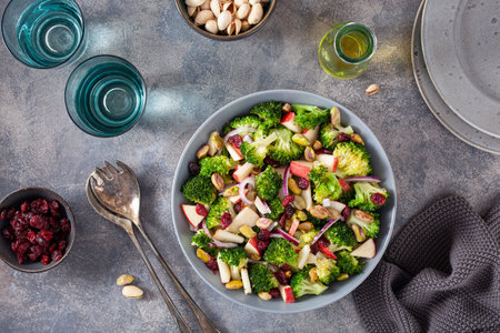 healthy broccoli salad with apple onion dried cranberries pistachio. vegan low carb dietの写真素材
