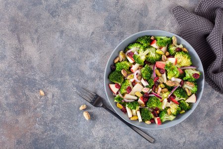 healthy broccoli salad with apple onion dried cranberries pistachio. vegan low carb dietの写真素材