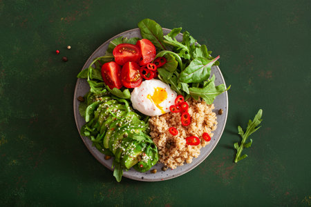 quinoa with poached egg, avocado tomato salad leaves. healthy vegetarian lunch breakfastの写真素材