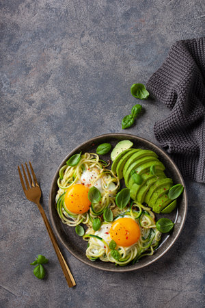 keto low carb breakfast baked spiralized zucchini with eggs and avocadoの写真素材