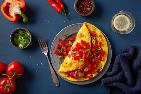omelette with tomato, bell pepper onion chili and cheese. healthy breakfastの写真素材