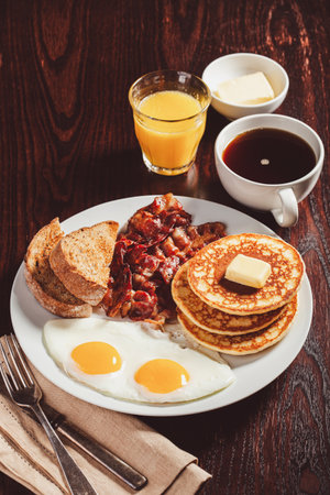 traditional full american breakfast eggs pancakes with bacon and toast