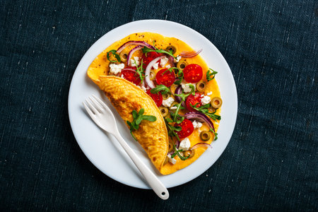 omelette with tomato, feta cheese onion and arugula. healthy keto diet low carb breakfast