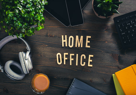 home office text desk with keyboard computer smartphone notebook houseplants, workspace office at homeの写真素材