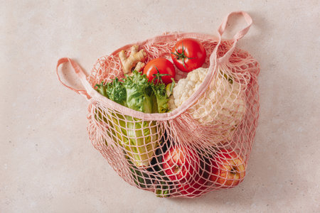 fruits vegetables in reusable mesh cotton bag, plastic free zero waste conceptの写真素材