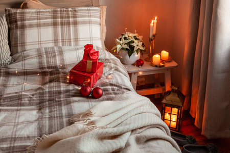 cozy scandinavian bedroom interior in natural tones, blanket candles christmas gift boxの写真素材