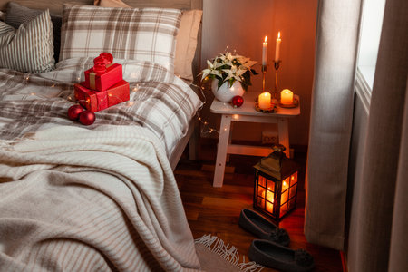 cozy scandinavian bedroom interior in natural tones, blanket candles christmas gift boxの写真素材