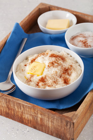 rice pudding with butter cinnamon. french riz au lait, norwegian risgrot, traditional breakfast dessertの写真素材