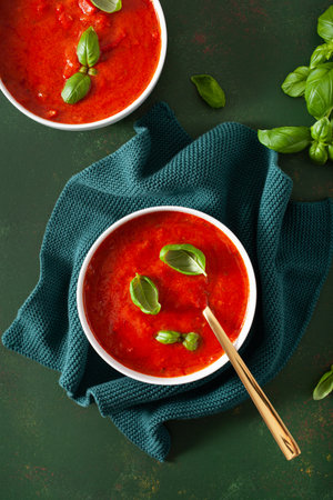 tomato and bell pepper vegetarian soup on green backgroundの写真素材