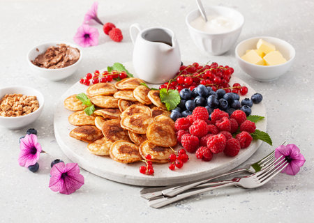 american mini pancake board with berries and maple syrupの写真素材