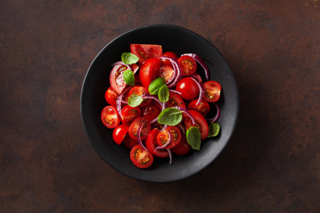 healthy tomato salad with onion basil olive oil and balsamic vinegarの写真素材