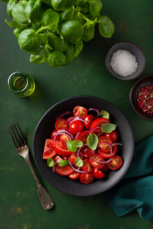 healthy tomato salad with onion basil olive oil and balsamic vinegarの写真素材