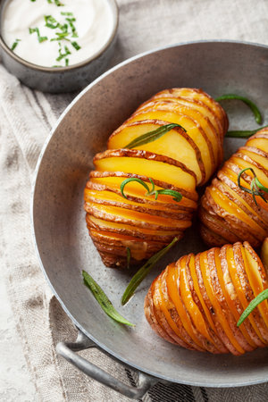 baked hasselback potato with cheddar cheese and rosemary