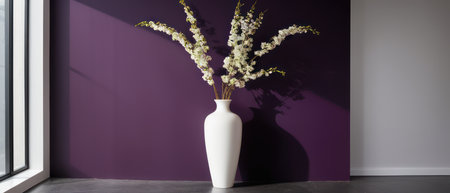 Elegant plant with white and purple flowers in a white vase, placed against a rich purple wall. Perfect for interior design and floral decor themes.の素材