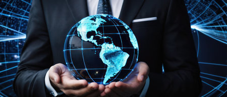 Businessman holding a digital globe in his hands. Concept of global business, network, connection, and technology.の素材