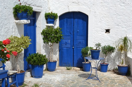 Typical greek courtyard with blue flower pots in Piskopiano on Crete, Greece.のeditorial素材