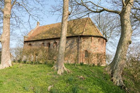 Mound with a church in Jannum in Friesland, Netherlands.の写真素材