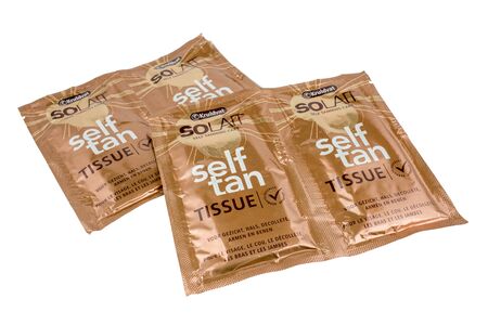 NETHERLANDS - LUNTEREN - JULY 24, 2017: Self tan tissues form Kruidvat company on a white background.のeditorial素材