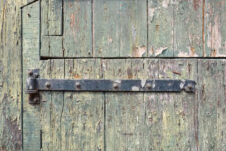 Old door rusty hinge in close-up.