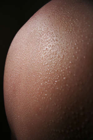 Drops of sweat on a womans backの写真素材