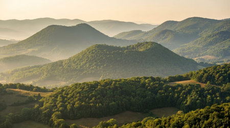 Untouched natural scenery at Garrotxa Volcanic Zone, featuring compressed landscape layers, regional terrain, and atmospheric sunrise without visible human made elements.