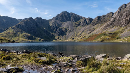 Llyn llydaw glacial lake at Eryri Snowdonia, Yr Wyddfa, Gwynedd, Wales, with dramatic slate gray rock slopes; authentic travel scenery and a clear unobstructed view.