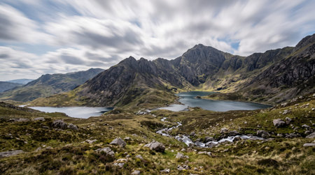Yr wyddfa snowdon mountain summit at Eryri Snowdonia, Yr Wyddfa, Gwynedd, Wales, with glacial mountain lakes; authentic travel scenery and a clear unobstructed view.