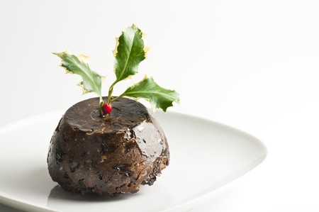 Traditional english Christmas pudding with holly leavesの写真素材