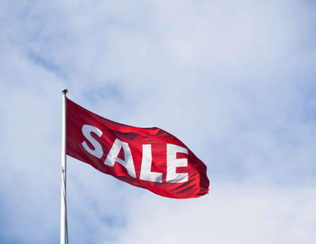 Sale flag flying in the windの写真素材