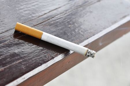 A cigarette on a wood tableの写真素材