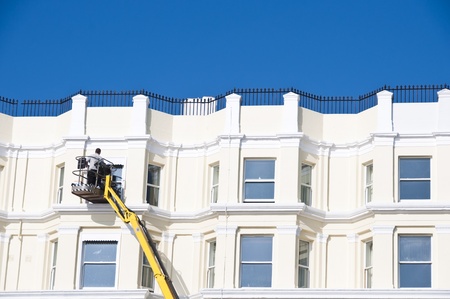A man cleaning sash windows from outside in the UKの写真素材