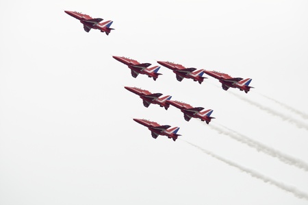 LONDON, UK, Saturday July 14, 2012. The Red Arrows from the Royal Air Force Aerobatic Team displaying at Farnborough International Airshow 2012. They fly on BAE Hawk Trainer T1A.のeditorial素材