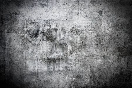 Dark and grungy concrete wall background with vignetteの写真素材