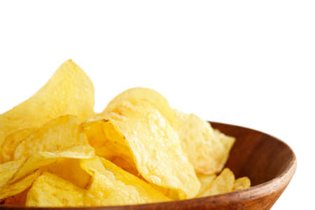 Crisps in a wooden bowl on white backgroundの写真素材