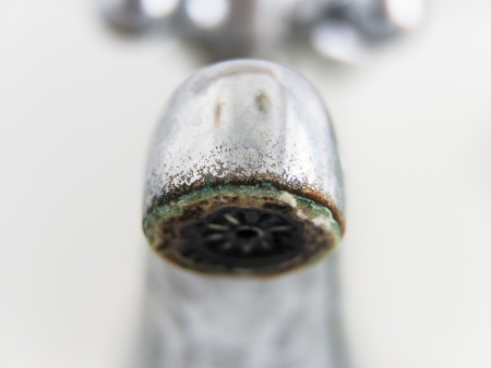 Old and grungy tap closeup, white backgroundの写真素材