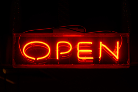 Red open neon sign in the nightの写真素材