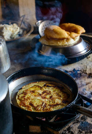 Preparing apple pancake and Gurung breads in nepalの写真素材