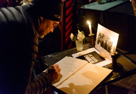 KATHMANDU, NEPAL - JANUARY 11, 2015: Man signing the condolences book at  the Caf des Arts gathering in tribute to the victims of the terrorist attacks in Paris.のeditorial素材