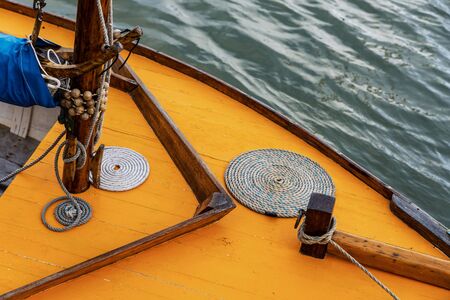 Detail of an orange vintage sail boatの写真素材