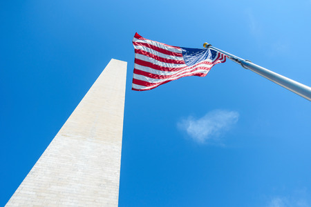 The Washington Monument and the flag of the United States of Americaの写真素材